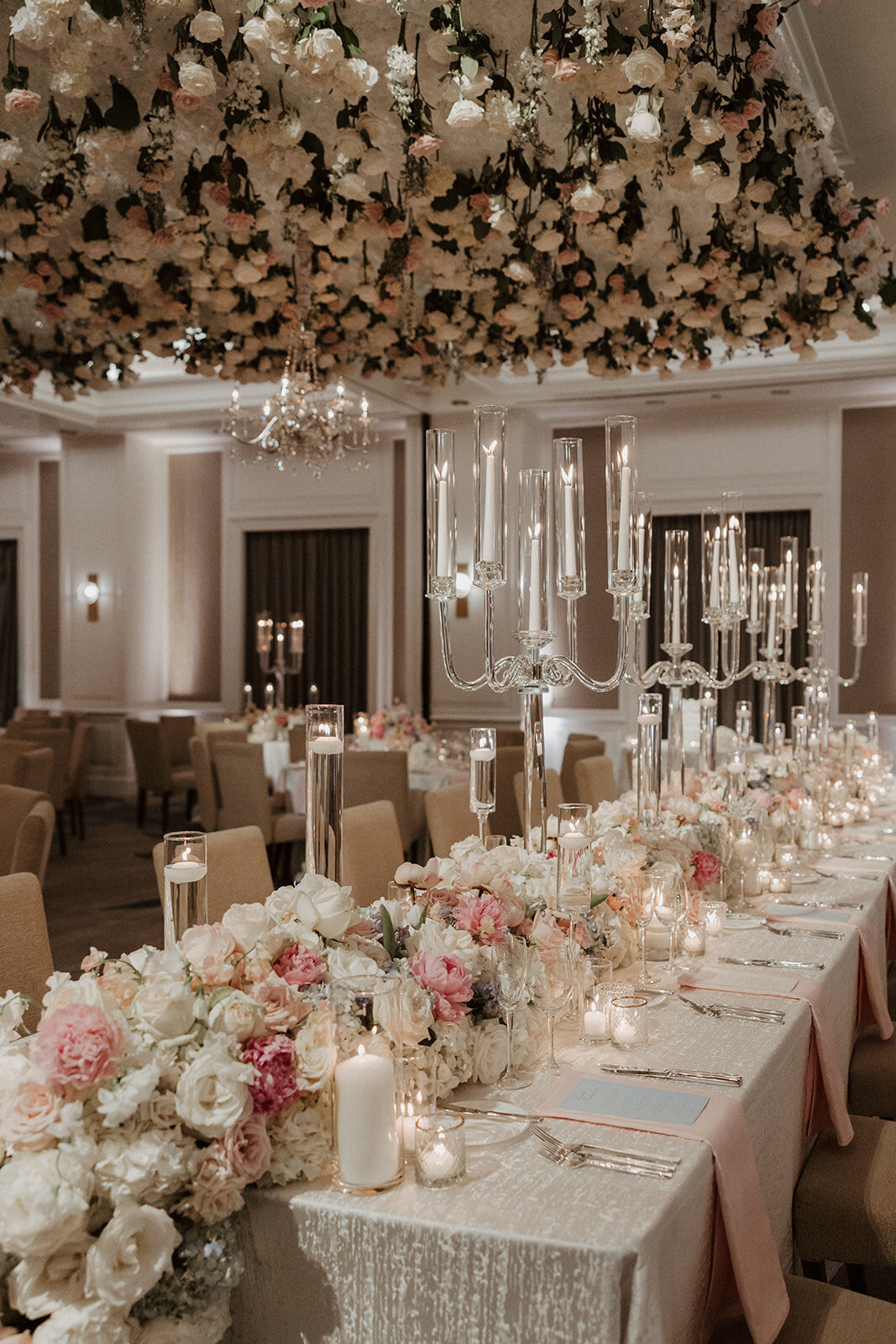 Candlelit luxury reception tablescape with layered place settings