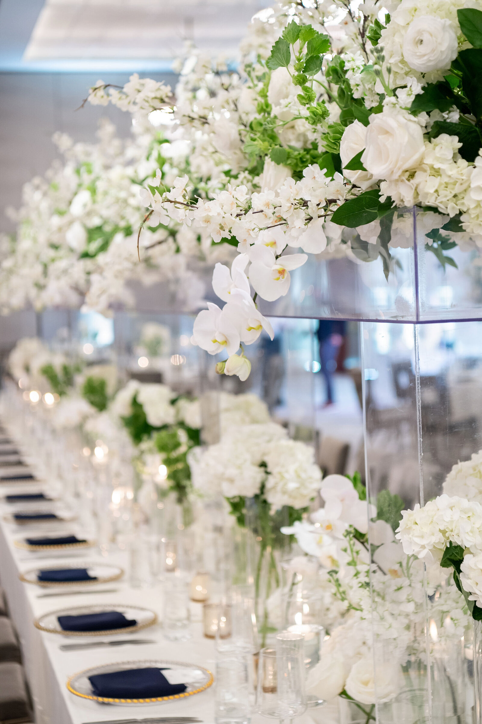 Modern reception tablescape in navy with tall candlelit centerpieces